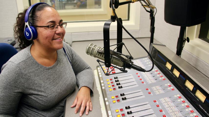 WTCC DJ in studio speaking into microphone